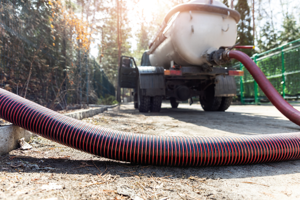 Close-up,Pipe,Hose,Of,Sewage,Truck,Car,Engine,Emptying,Home